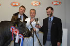 Michel Vincent presents the Championship trophy to Mel Lucas, while Richard carruthers, Chairman of the Border Belgian Blue club looks on.