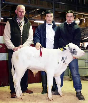 Pictured with the Sowray brothers’ 2013 Christmas calf show champion are, from left, judge Phil Summers and family members George Sowray and James Dixon