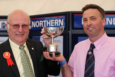 Con Williamson, Judge of the Blue classes at Balmoral presents Andrew Craig, Coleraine with the Thompson Perpetual Cup for the Best Young Heifer at Balmoral Show.