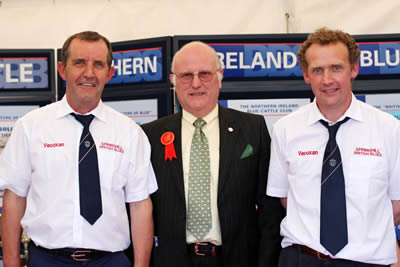 Michael Woods, left, President, Belgian Blue Cattle Society Ireland presents a trophy to Johnny Young,Ballynahinch fot the Best Blue Male at Balmoral Show.