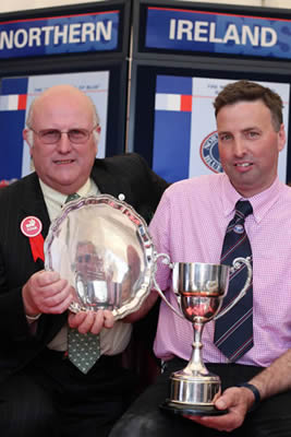 Andrew Craig, Coleraine, receives an award from Con Williamson, Judge of the Blue classes at Balmoral for his Champion Female and Supreme Champion at Balmoral Show.  