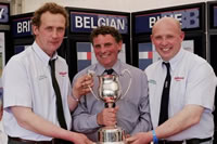 Jim Barber, Cheshire, Belgian Blue judge at Balmoral Show presents a trophy to Thomas and James Martin, Martin Brothers, Newtownards.